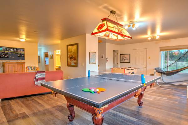 Photo of recreation room with pool table and ping pong table top