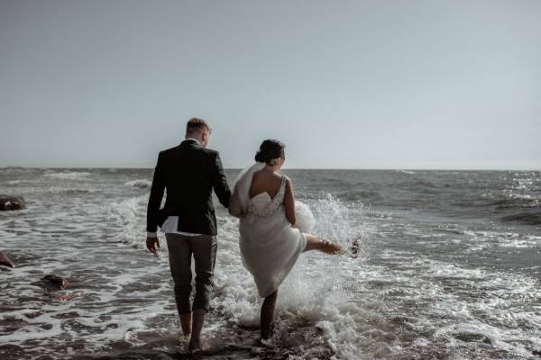 Married couple splashing water at the beach