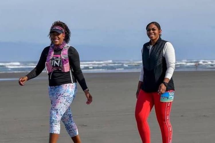 Two women walking on the beach  