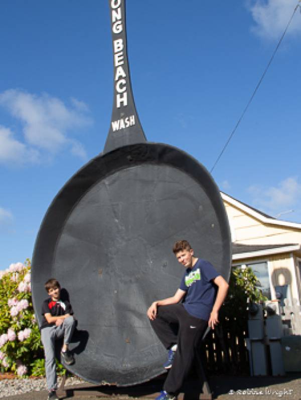 People love to have their photos taken next to the "World's Largest Frying Pan" Two kids in front of the Long Beach WA worlds largest Frying Pan