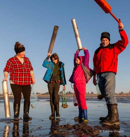 Clam digging is fun for the entire family Family holding up clam guns in Long Beach WA