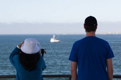 Couple gaze off of the storm tower in Westport WA Couple gaze off of the storm tower in Westport WA