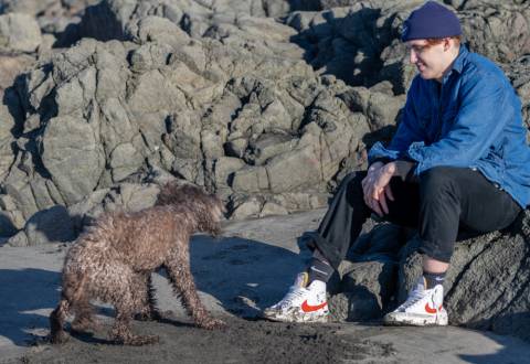 Bonding with man's best friend Boy with dog on the beach