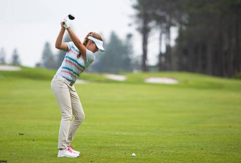 A woman playing golf